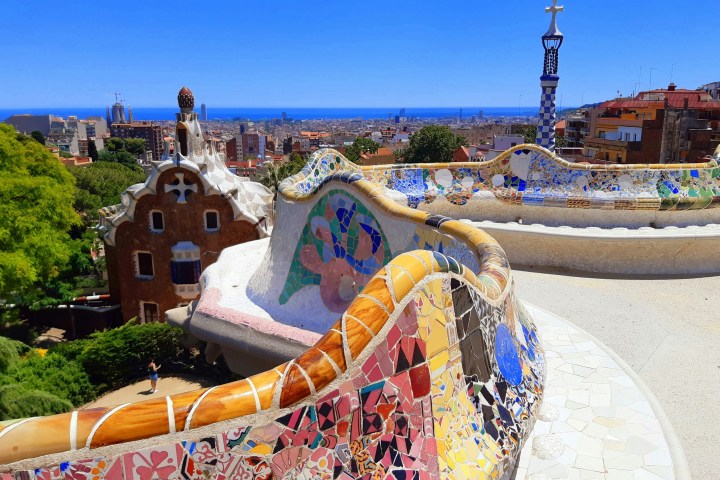 Colorful mosaic terrace with ocean view in Park Güell, Barcelona.